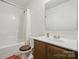 Well-lit bathroom with a shower-tub combination and a vanity with a large mirror at 3944 Hemingway Nw Dr, Hickory, NC 28601