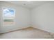 A carpeted bedroom with natural light from the window at 3944 Hemingway Nw Dr, Hickory, NC 28601