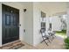 Inviting front porch with a black door, seating, and windows for natural light at 3944 Hemingway Nw Dr, Hickory, NC 28601