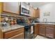Contemporary kitchen with stainless steel microwave and range, and warm wood cabinets at 3944 Hemingway Nw Dr, Hickory, NC 28601