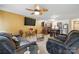 Spacious living area open to kitchen, with sofas, a ceiling fan, and a TV at 3944 Hemingway Nw Dr, Hickory, NC 28601