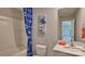Bathroom featuring a shower-tub combo, modern fixtures, and stylish blue accents at 4025 Cramer Estates Ct, Gastonia, NC 28056