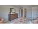 Comfortable carpeted bedroom with dresser, mirror and two access doors at 4025 Cramer Estates Ct, Gastonia, NC 28056