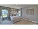 Bright bedroom with neutral walls, carpet, natural light from windows, and decor at 4025 Cramer Estates Ct, Gastonia, NC 28056