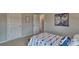 Carpeted bedroom featuring a bed with patterned linens and two access doors at 4025 Cramer Estates Ct, Gastonia, NC 28056
