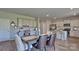 Bright dining area with gray walls, wood floors, desk area, and modern light gray kitchen in a new home at 4025 Cramer Estates Ct, Gastonia, NC 28056