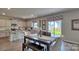 Open-concept dining area with island and sliding glass door to backyard at 4025 Cramer Estates Ct, Gastonia, NC 28056