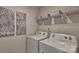 Bright laundry room with new washer and dryer, plus white wire rack for storage at 4025 Cramer Estates Ct, Gastonia, NC 28056