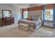 Spacious main bedroom with a tufted headboard, stylish decor, and mirrored nightstands at 4025 Cramer Estates Ct, Gastonia, NC 28056