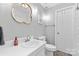 Modern bathroom featuring a white vanity, decorative mirror, and soft lighting, creating a bright and inviting space at 4607 Hedgemore Dr # D, Charlotte, NC 28209