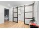 Bedroom closet featuring sliding barn doors, offering storage space with drawers and shelves for organized clothing and accessories at 4607 Hedgemore Dr # D, Charlotte, NC 28209