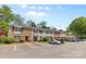 A row of brick townhomes with well-maintained landscaping and ample parking, showcasing a desirable community at 4607 Hedgemore Dr # D, Charlotte, NC 28209
