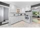 Bright kitchen featuring white cabinets, subway tile backsplash, stainless steel appliances, and hexagonal tile floor at 4607 Hedgemore Dr # D, Charlotte, NC 28209