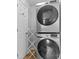 Efficient laundry area featuring a stacked washer and dryer to maximize space in a compact design at 4607 Hedgemore Dr # D, Charlotte, NC 28209