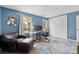 Comfortable home office with light blue walls, desk setup, leather chair, and decorative rug enhancing its appeal at 4607 Hedgemore Dr # D, Charlotte, NC 28209