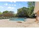 Community pool area with lounge chairs and mature trees providing a relaxing and refreshing outdoor amenity at 4607 Hedgemore Dr # D, Charlotte, NC 28209