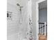 Shower with white subway tile, rainfall showerhead, and clear curtain allowing light into the space at 4607 Hedgemore Dr # D, Charlotte, NC 28209