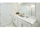Bright bathroom features a double sink vanity, white cabinets, and framed mirror over a white countertop at 4610 Harris Elliot Rd, Lincolnton, NC 28092