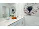 Bathroom with double sinks, white cabinets, and a large dandelion art piece on the wall at 4610 Harris Elliot Rd, Lincolnton, NC 28092
