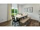 Bright dining area with modern table, bench, and view to lush backyard at 4610 Harris Elliot Rd, Lincolnton, NC 28092