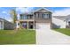 Charming two-story home with a brick and gray siding, a well-manicured lawn, and an attached two-car garage at 4610 Harris Elliot Rd, Lincolnton, NC 28092