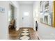 Bright hallway with wood floors, a patterned rug, and an elegant painting on the white wall at 4610 Harris Elliot Rd, Lincolnton, NC 28092