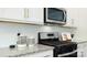 Modern kitchen features granite countertops, stainless steel appliances, and white cabinets at 4610 Harris Elliot Rd, Lincolnton, NC 28092