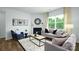 Cozy living room featuring a fireplace, stylish seating, and a large window at 4610 Harris Elliot Rd, Lincolnton, NC 28092