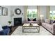 Comfortable living room with a fireplace, large window, and neutral-toned furniture at 4610 Harris Elliot Rd, Lincolnton, NC 28092