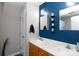 Well-lit bathroom featuring a double vanity and striking blue accent wall at 5015 Drake Pond Ln, Rock Hill, SC 29732