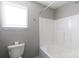 Full bathroom features white shower and toilet. Natural light from window at 5015 Drake Pond Ln, Rock Hill, SC 29732