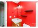 Bathroom featuring red accent wall with floating shelves and a toilet at 5015 Drake Pond Ln, Rock Hill, SC 29732
