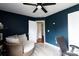 Bedroom with a cozy chair, decorated with inviting blue walls and soft lighting at 5015 Drake Pond Ln, Rock Hill, SC 29732