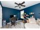 Comfortable bedroom with a ceiling fan, desk, and bookshelf, styled in blue at 5015 Drake Pond Ln, Rock Hill, SC 29732