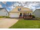 Charming two-story home featuring a welcoming front porch, attached garage and a well maintained lawn at 5015 Drake Pond Ln, Rock Hill, SC 29732