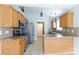 Open kitchen with stainless steel appliances, oak cabinets, and a breakfast bar at 5015 Drake Pond Ln, Rock Hill, SC 29732