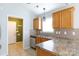 Close-up of stainless steel appliances and oak cabinets in the kitchen at 5015 Drake Pond Ln, Rock Hill, SC 29732