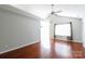 Bright living room features a ceiling fan, hardwood floors, and large window at 5015 Drake Pond Ln, Rock Hill, SC 29732