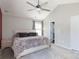 Serene main bedroom with a vaulted ceiling, plush bed, ceiling fan and ample natural light creating a relaxing retreat at 5015 Drake Pond Ln, Rock Hill, SC 29732