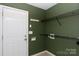 A bright mud room with storage shelves and a white door at 5015 Drake Pond Ln, Rock Hill, SC 29732