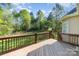 Spacious backyard with wooden deck, lush lawn, and playground at 5108 Boardwalk Ct, Dallas, NC 28034