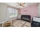 Cozy Bedroom features a black crib against a pink accent wall and large window at 5108 Boardwalk Ct, Dallas, NC 28034