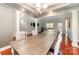 Open concept dining area with wood table, hardwood floors, and views to the adjacent living room at 5108 Boardwalk Ct, Dallas, NC 28034