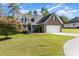 Charming brick home featuring a two-car garage, well-manicured lawn, and inviting front porch at 5108 Boardwalk Ct, Dallas, NC 28034