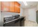 Spacious laundry room with front load washer and dryer, tile floor, and overhead cabinets at 5108 Boardwalk Ct, Dallas, NC 28034
