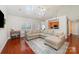 Bright living room features a sectional couch, wood floors, skylights, and an open layout at 5108 Boardwalk Ct, Dallas, NC 28034