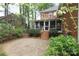 Outdoor living space featuring a brick patio, a screened-in porch, and mature landscaping at 6910 Green Turtle Dr, Charlotte, NC 28210