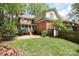 Backyard featuring a brick patio, a screened-in porch, mature trees, and landscaping at 6910 Green Turtle Dr, Charlotte, NC 28210