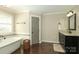 Bright bathroom featuring a standalone tub, a neutral color palette, and a large window that lets in natural light at 6910 Green Turtle Dr, Charlotte, NC 28210