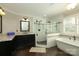 Well-lit bathroom featuring a standalone tub, walk-in shower, dark cabinets, and a neutral color palette at 6910 Green Turtle Dr, Charlotte, NC 28210